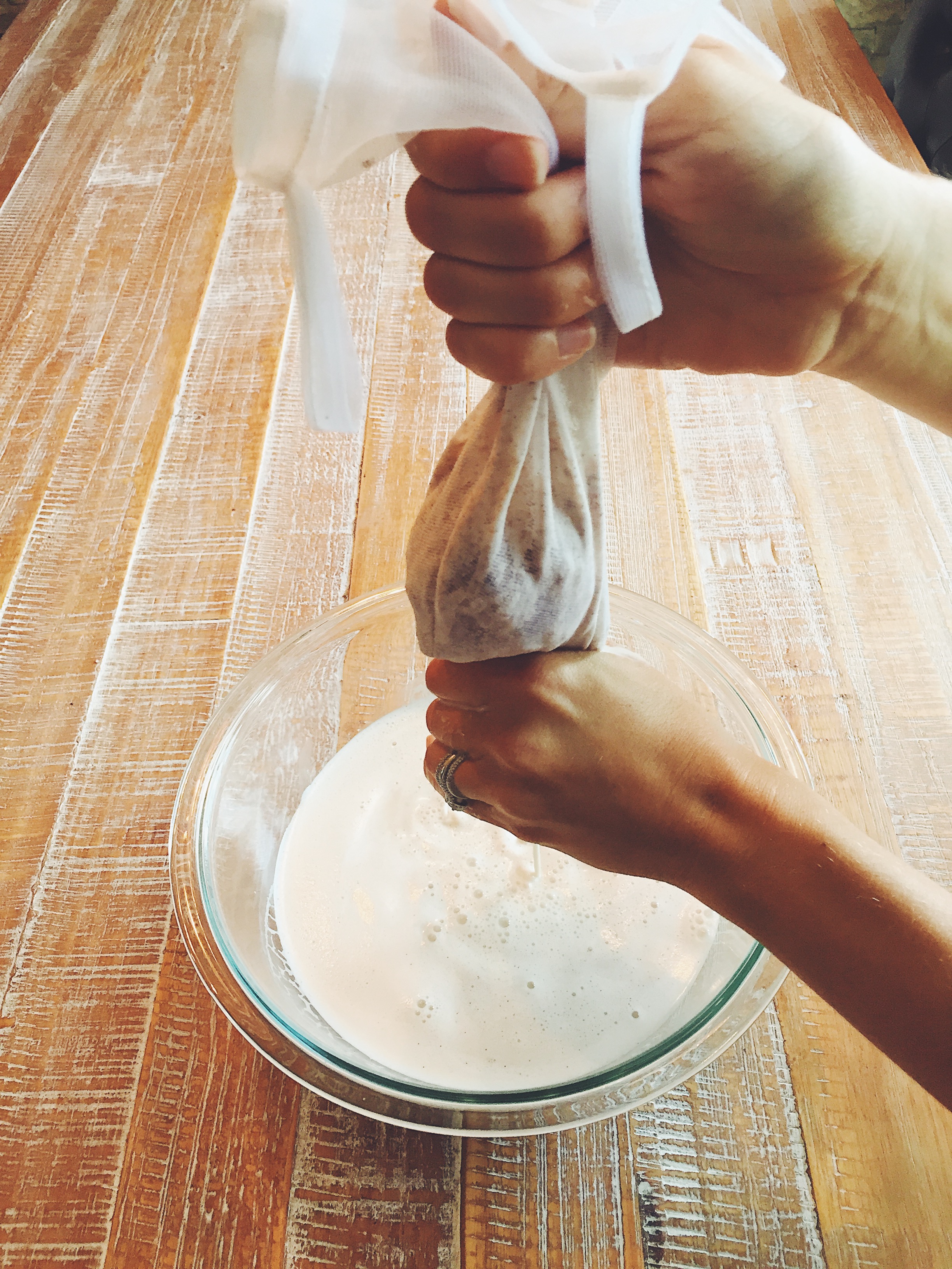 Gently squeeze the milk out of the nut milk bag