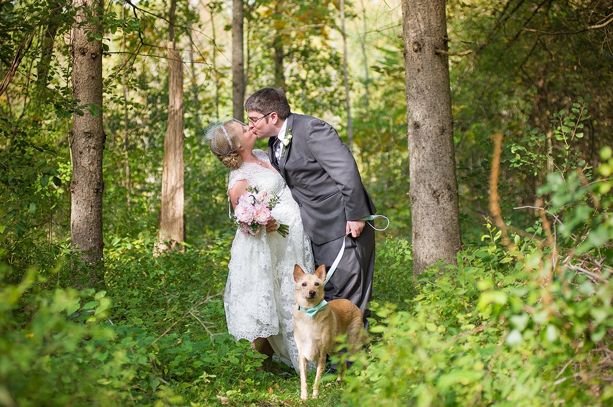 sweet photo of bride and groom with their dog