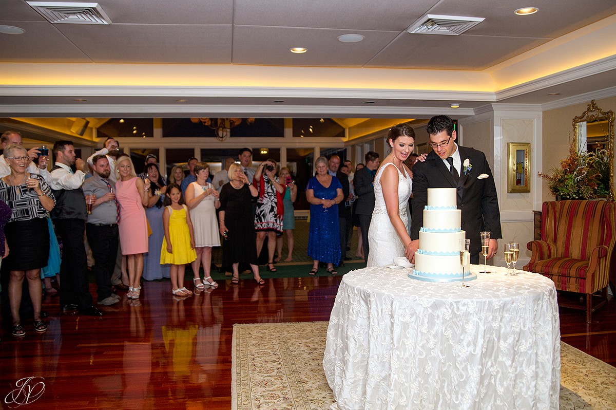 bride and groom cutting the cake at reception