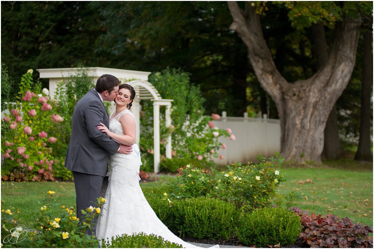 groom kissing bride cheek the mansion inn