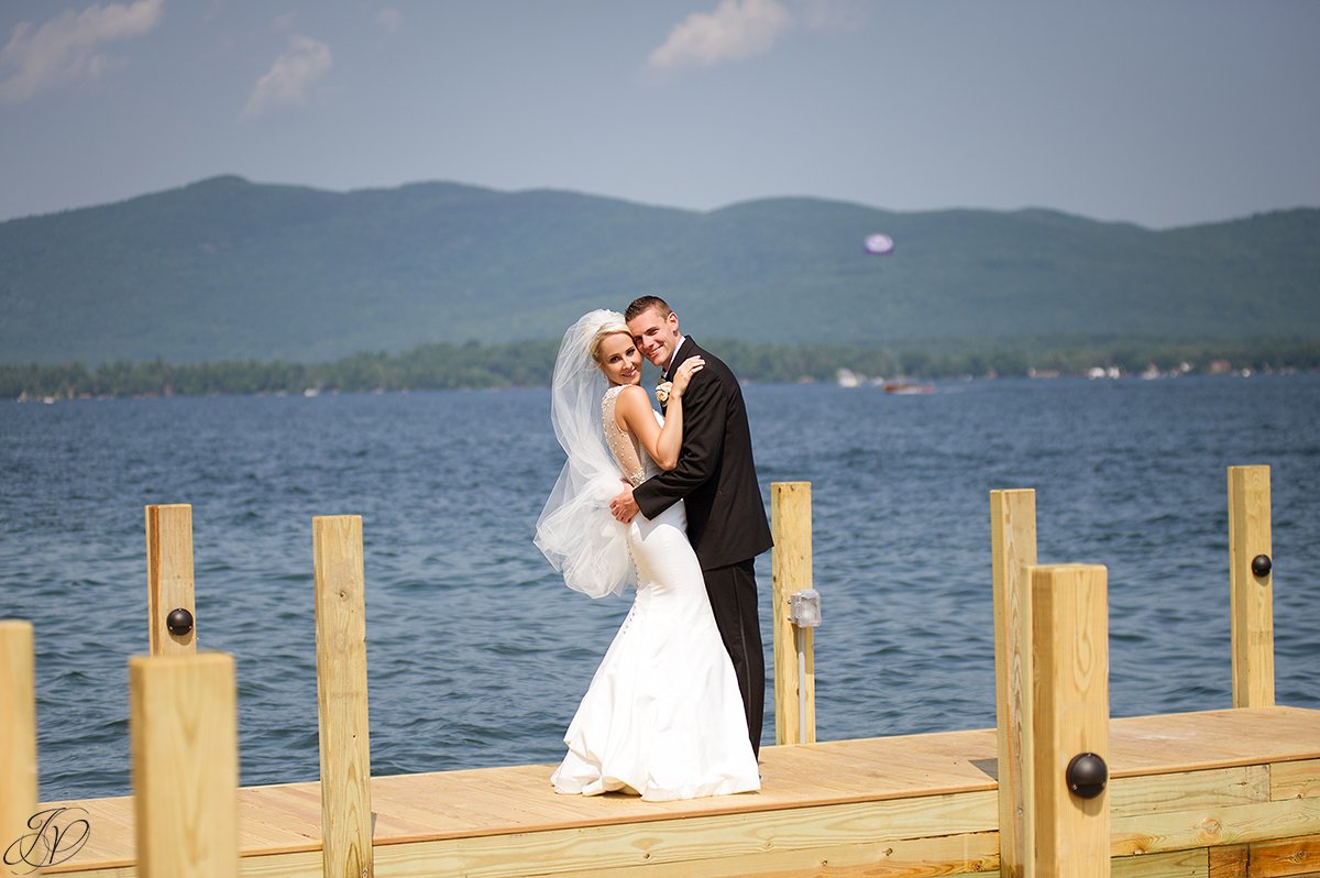 bride and groom on dock on lake lake george