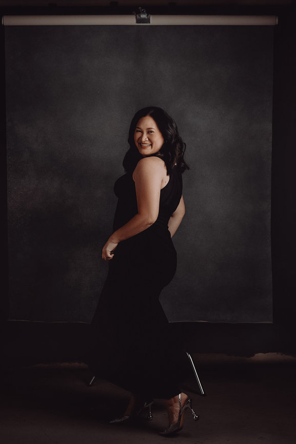 Elegant professional studio portrait with black dress and dark hand painted studio backdrops, taken in a photo studio with Adam Trujillo, a Las Vegas portrait photographer.