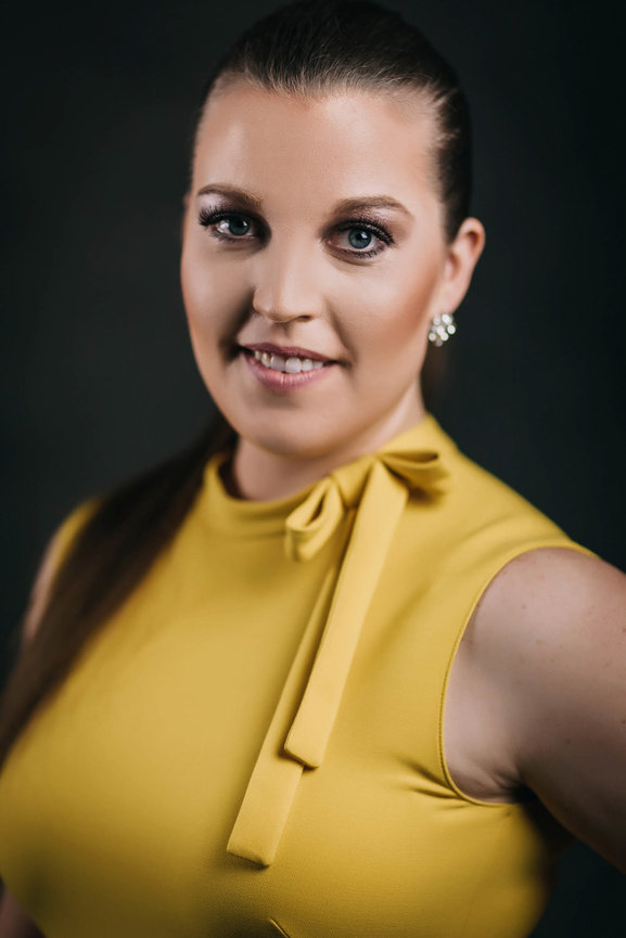 Iconic female headshot in studio with fancy yellow dress and studio lighting. Professional headshots and team portraits in studio with Adam Trujillo.