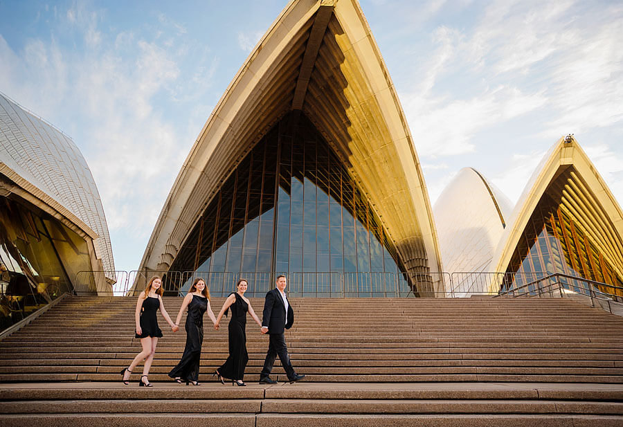Family walking in formal dress with a stunning back drop of the Sydney Opera House.