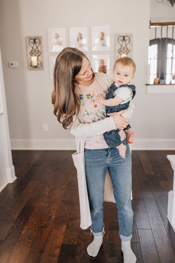 a mother stands holding her baby in a Huntsville Alabama family photoshoot.