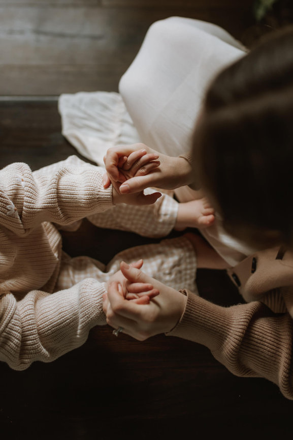 A mother and daughter holding hands on a staircase in New Jersey.