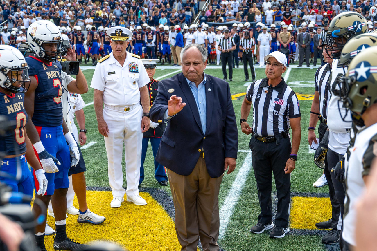 Secretary of the Navy performing a coin toss at a Navy vs Air Force Football game