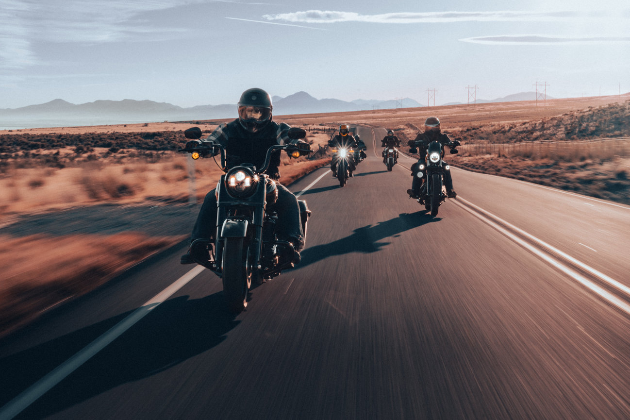 Group of motorcyclists riding together on an open road during a sunset roller shoot in Saratoga, Utah, capturing the spirit of freedom and camaraderie. Captured by Tre Nelson Photo.