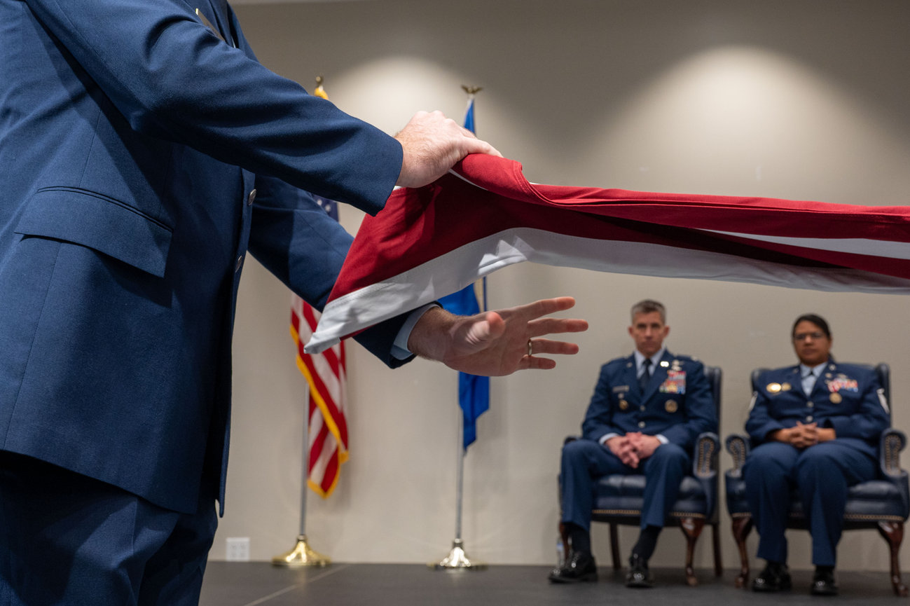 Flag folding ceremony during a USAF retirement ceremony photographed by Laura Hatcher Photography