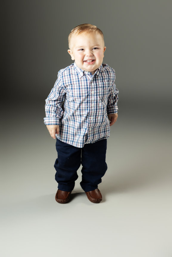 Boy in plaid shirt smiling