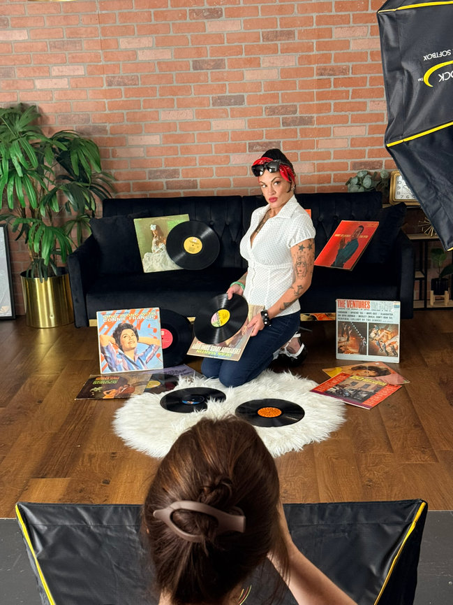 Behind the scenes women's portrait photography Orlando - photographer shooting rockabilly styled woman with vintage vinyl records, She's More Than by Karen K Photo