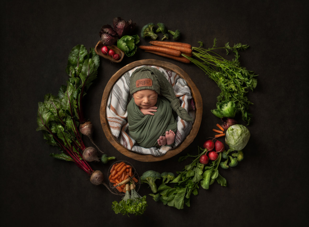 Newborn baby swaddled in bowl with veggies - farm baby in Harlingen, TX
