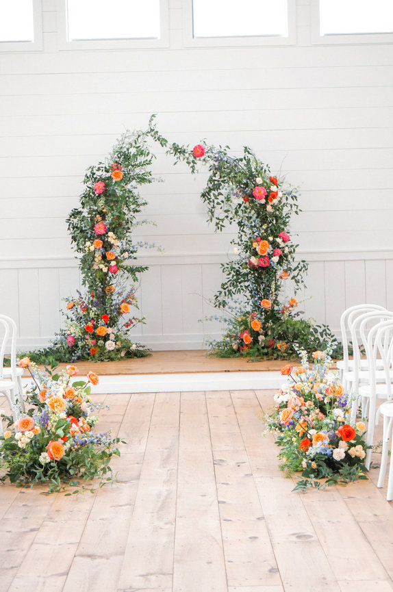 Colorfull wedding ceremony installation in MonTgomery , altar and aisle floral in peach pink and blues