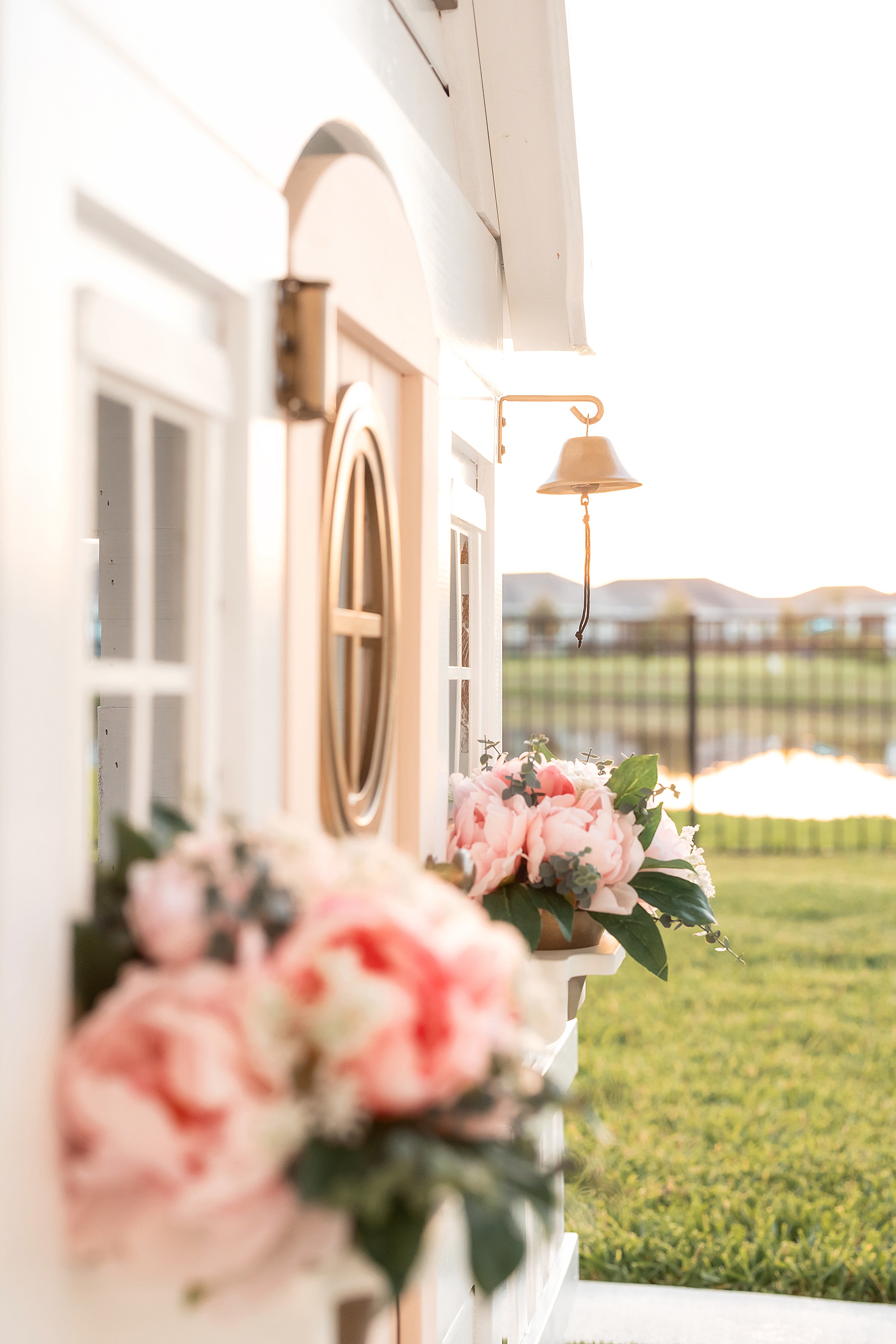 kids dream playhouse makeover with pink door and white walls