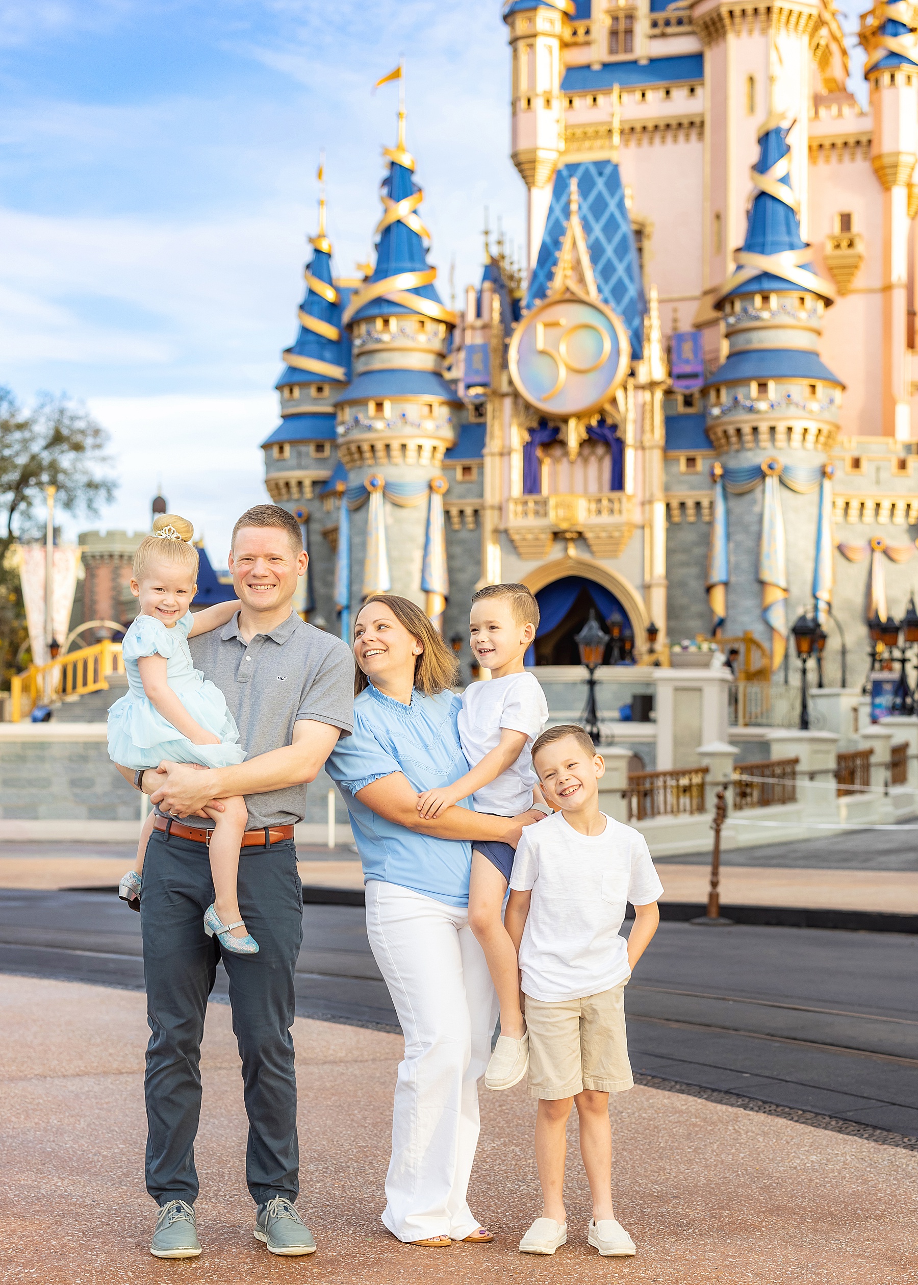 family standing in front of Cinderella's Castle at Magic Kingdom Orlando Florida