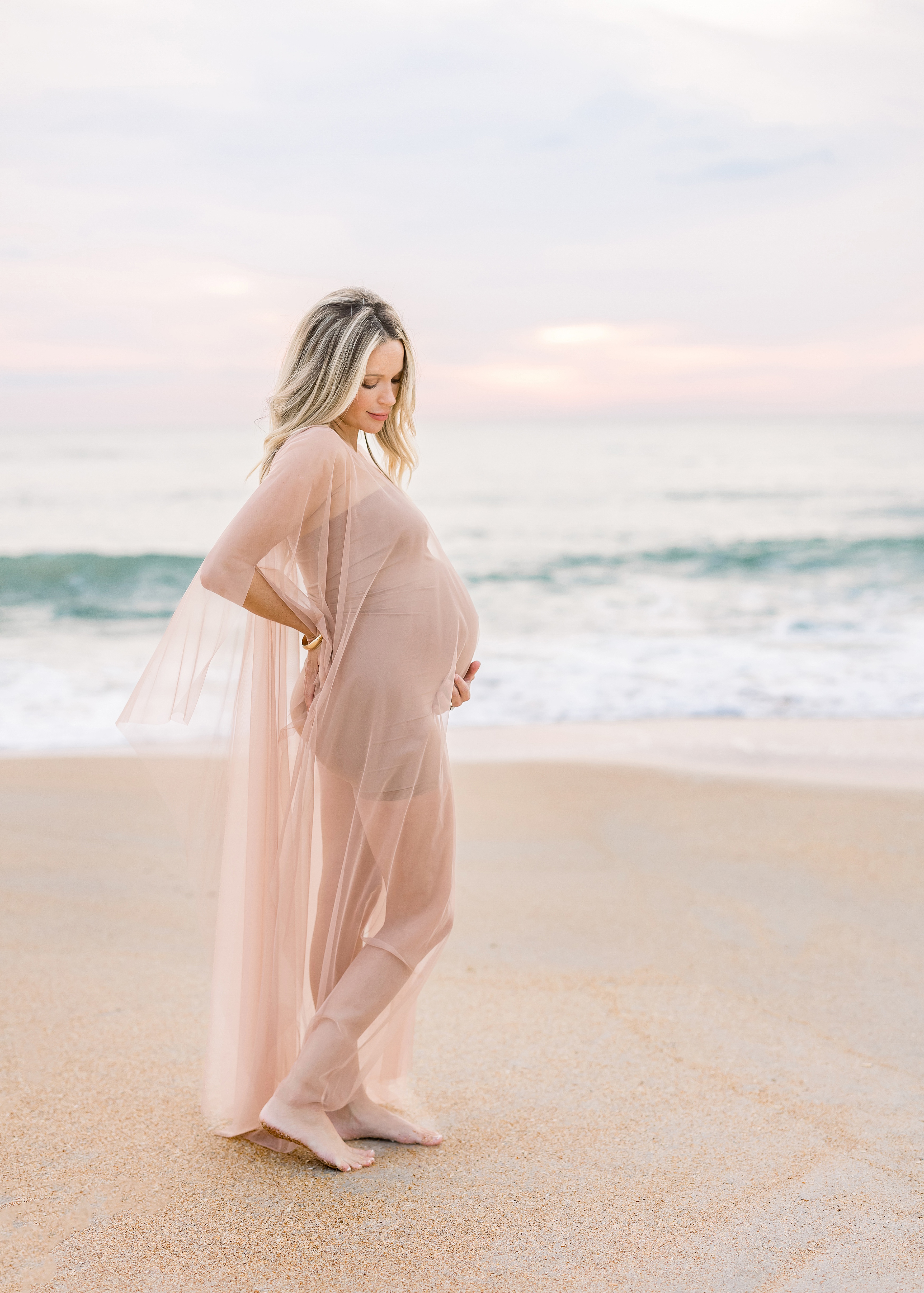 pregnancy portrait of woman at the beach at sunrise