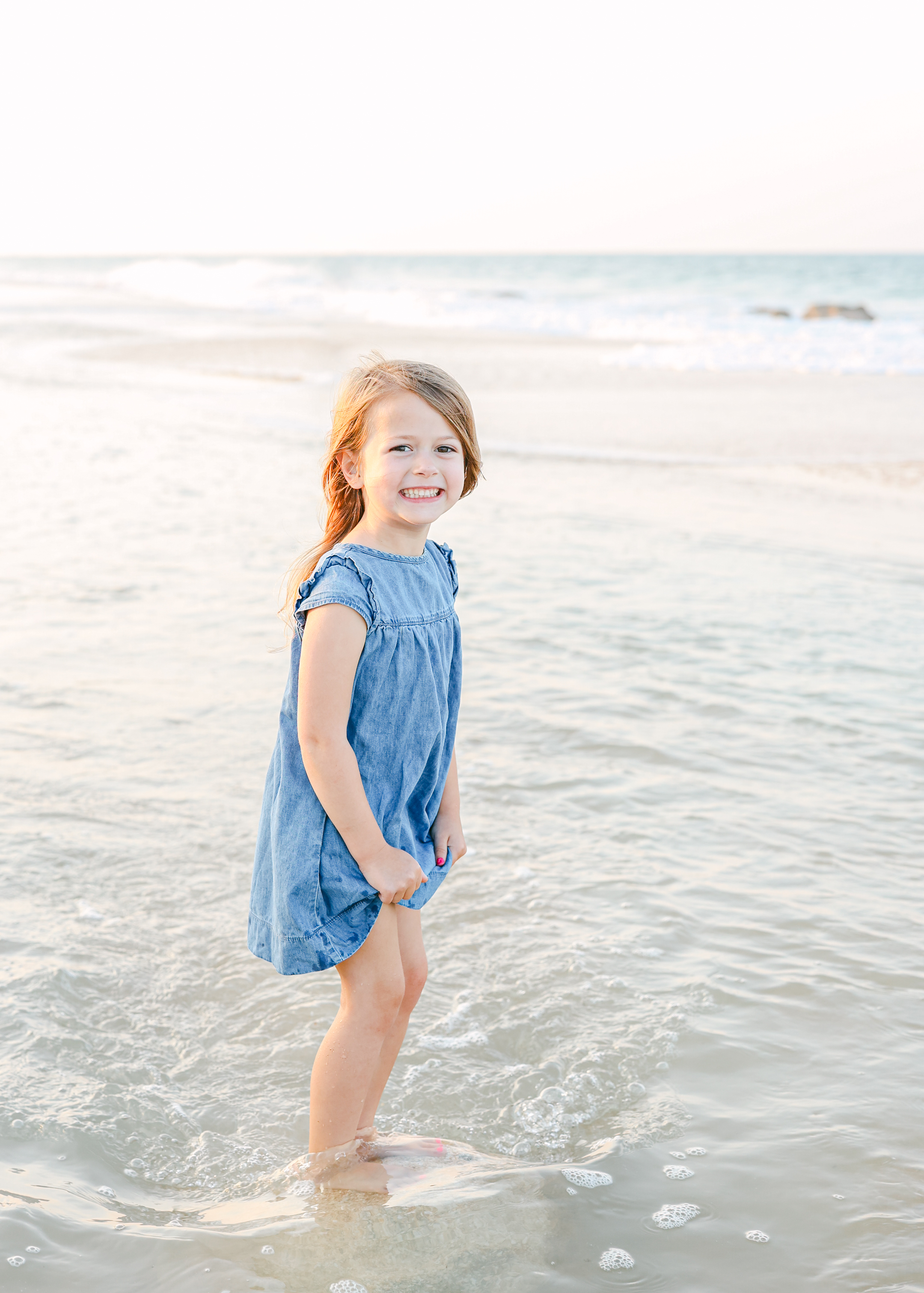 Sunset beach portrait of little girl in blue dress on the beach in St. Augustine.