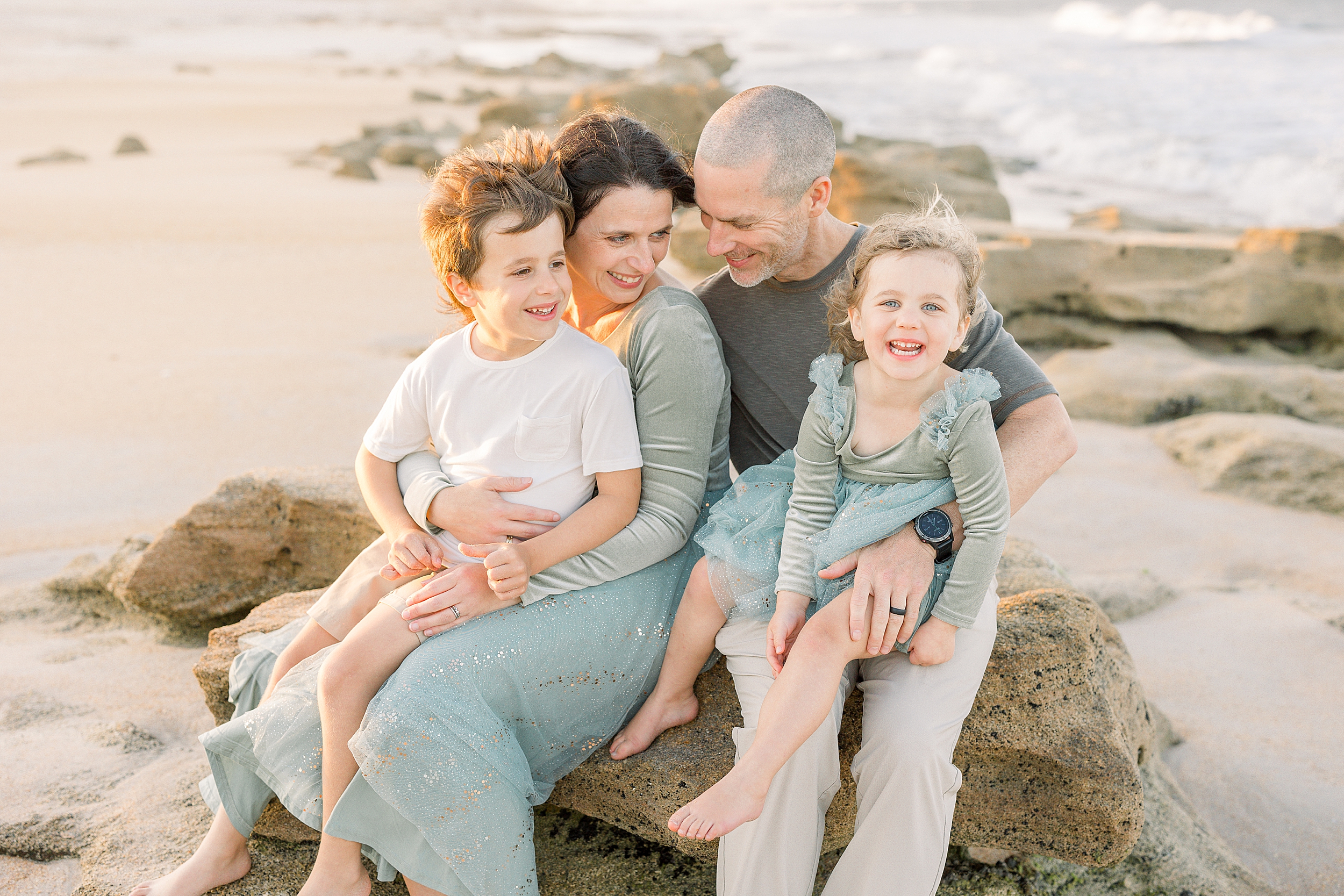 A light and airy family beach portrait at sunset in St. Augustine Beach, Florida.