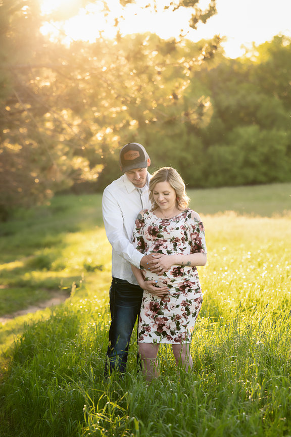 Couple cuddling in a field, Onalaska Maternity Photographer