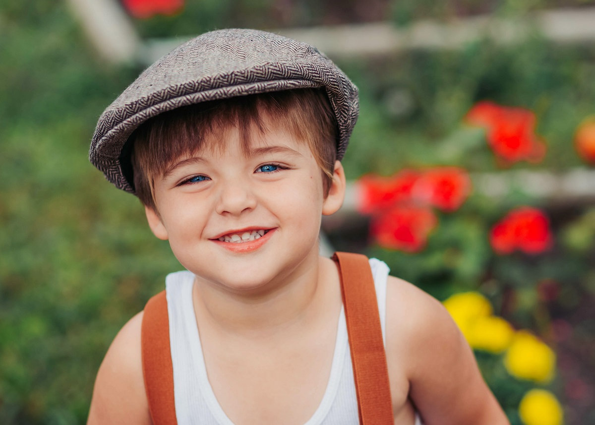 little boy in newsie hat and suspenders