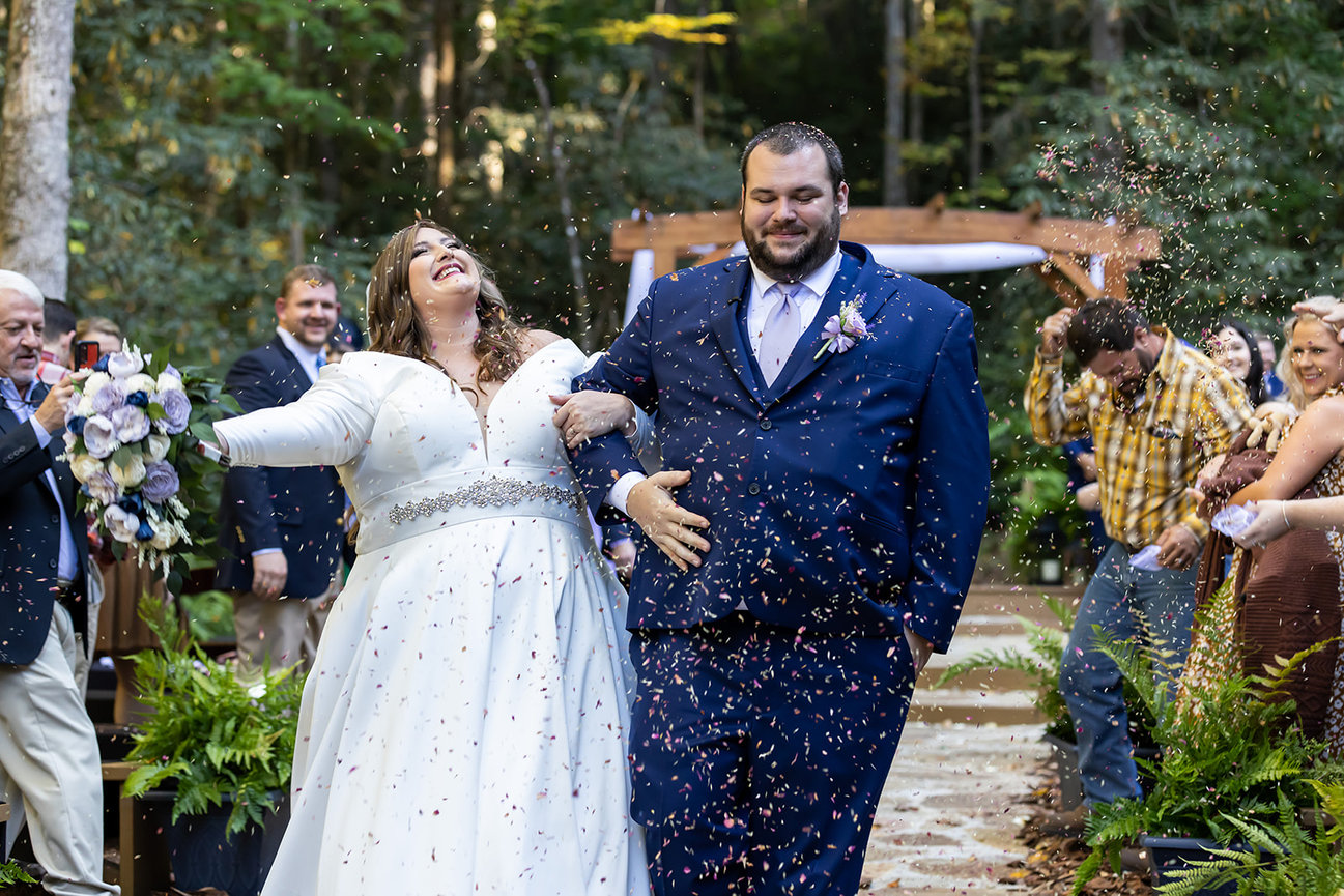 Joyful couple exiting wedding ceremony