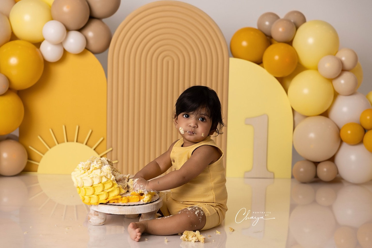 Baby exploring a yellow ombre cake during a custom cake smash session