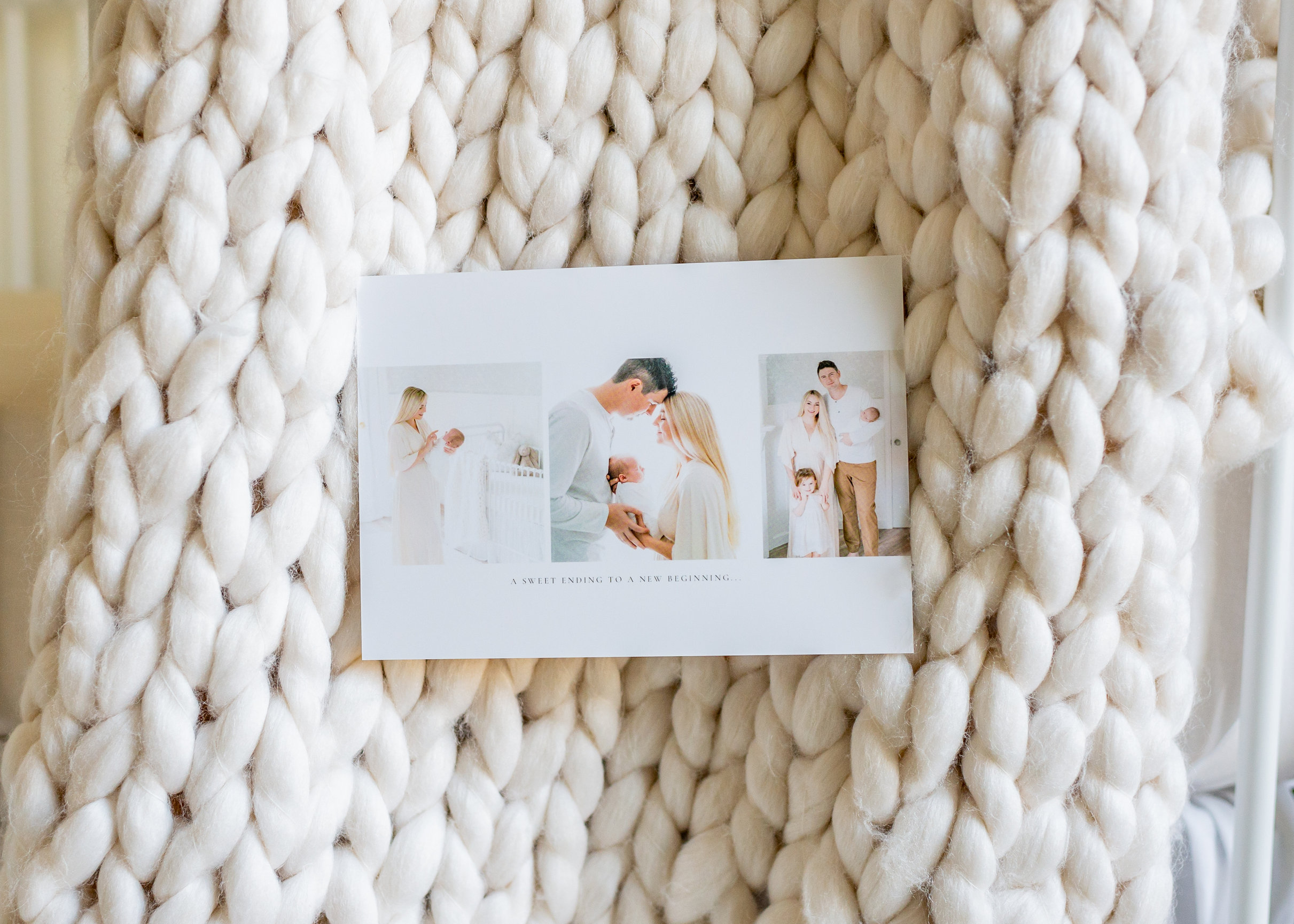 simple and bright birth announcement tucked into a large ivory knit blanket