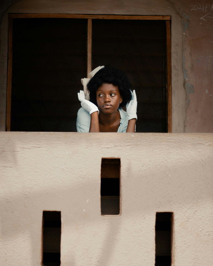 Woman standing by architectural window