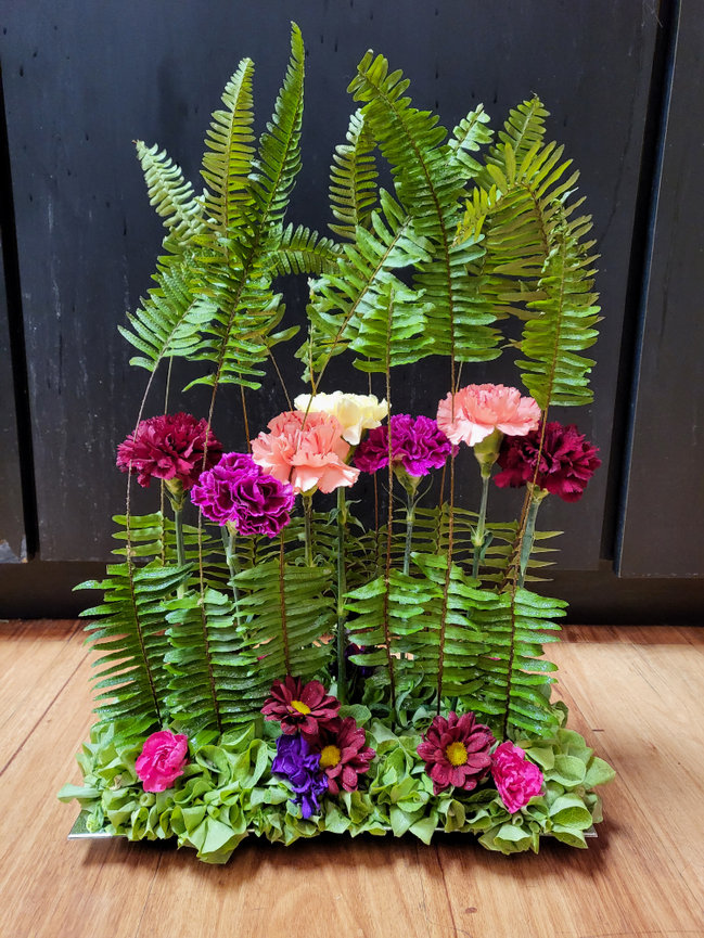 Arranged pink carnations and ferns