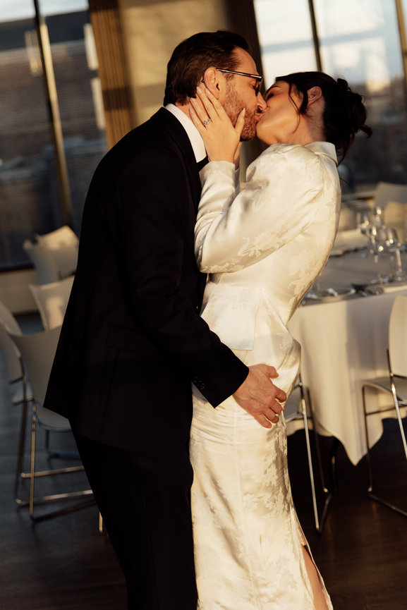 Cinematic wedding photography of a bride and groom sharing a romantic kiss in the golden hour light at Hope Street Hotel, Liverpool.