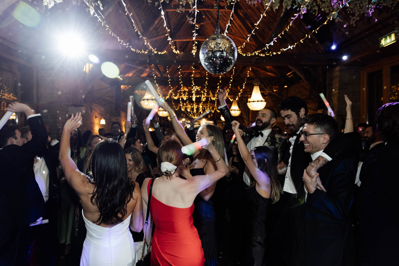 Candid flash photography at Tythe, Launton; a candid, high-energy shot of wedding guests on the dance floor.