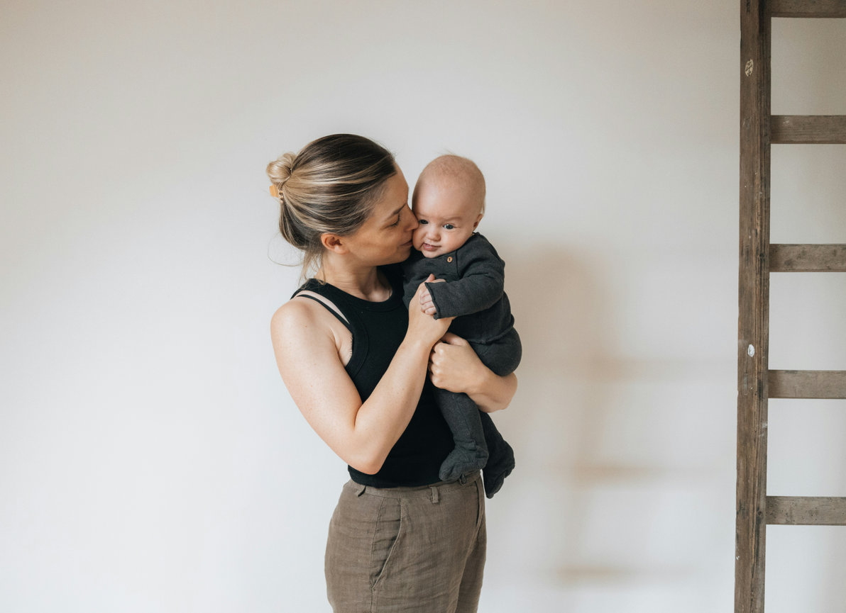 Mother holding her baby in a bright indoor portrait