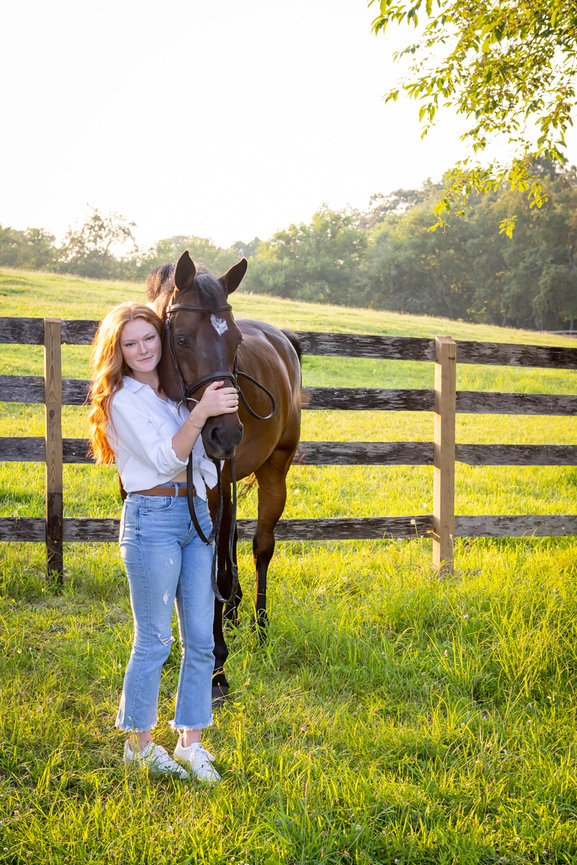Confident high school senior with her horse