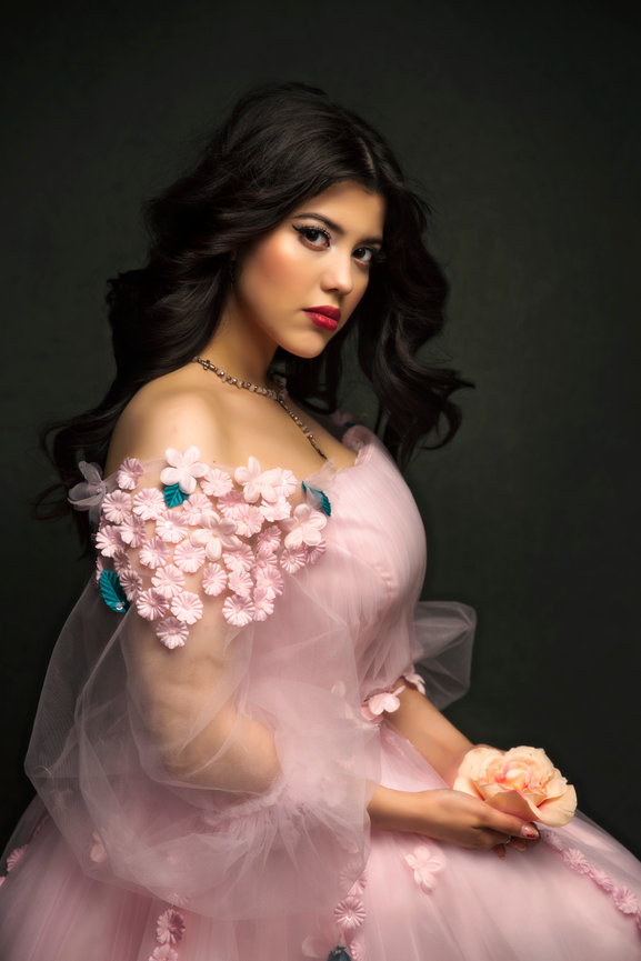 Fine art senior portrait in Colleyville studio with woman in pink floral gown.