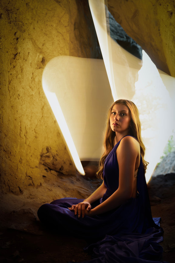 Light painting portrait inside cave with glowing backdrop and blue gown, Dallas Fort Worth creative portraits