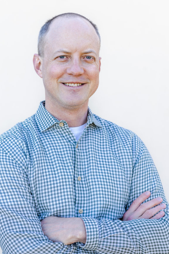 Professional headshot of San Francisco man crossing his arms and smiling.