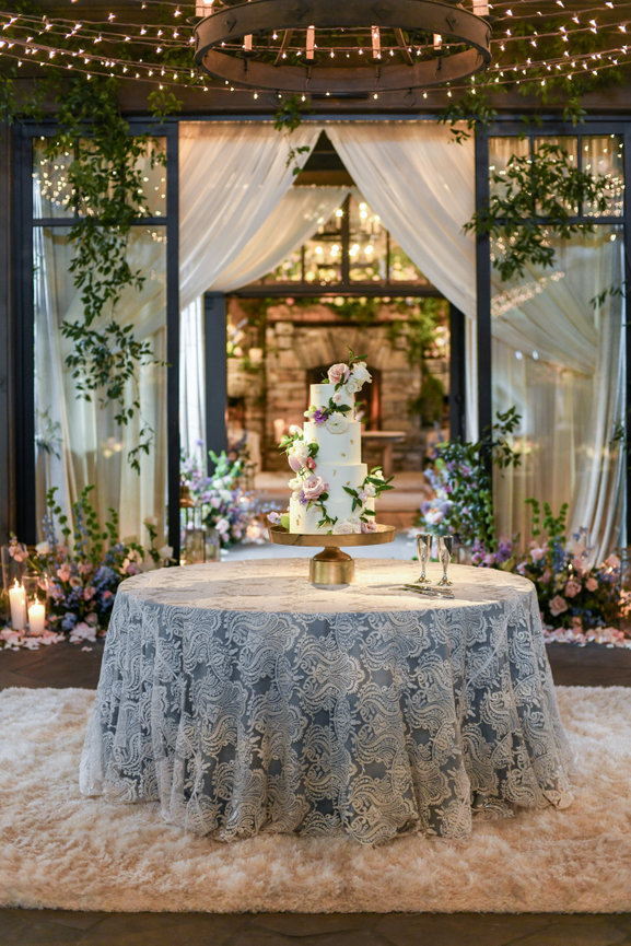 Dramatic florals and stunning wedding cake on lace table cloth at The Farm at Old Edwards in Highlands, North Carolina. Destination wedding photography by Heather Durham.