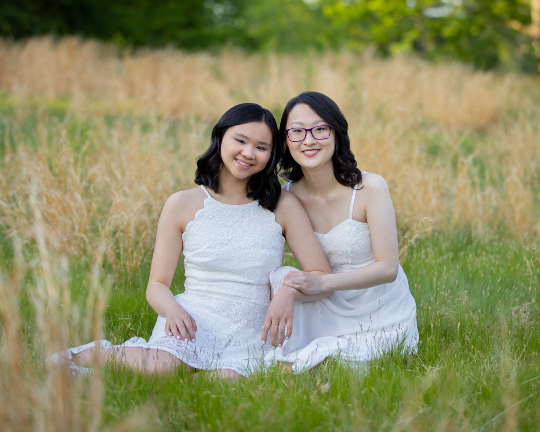 Outdoor portrait of two teenaged sisters in white dresses in field norwood ma