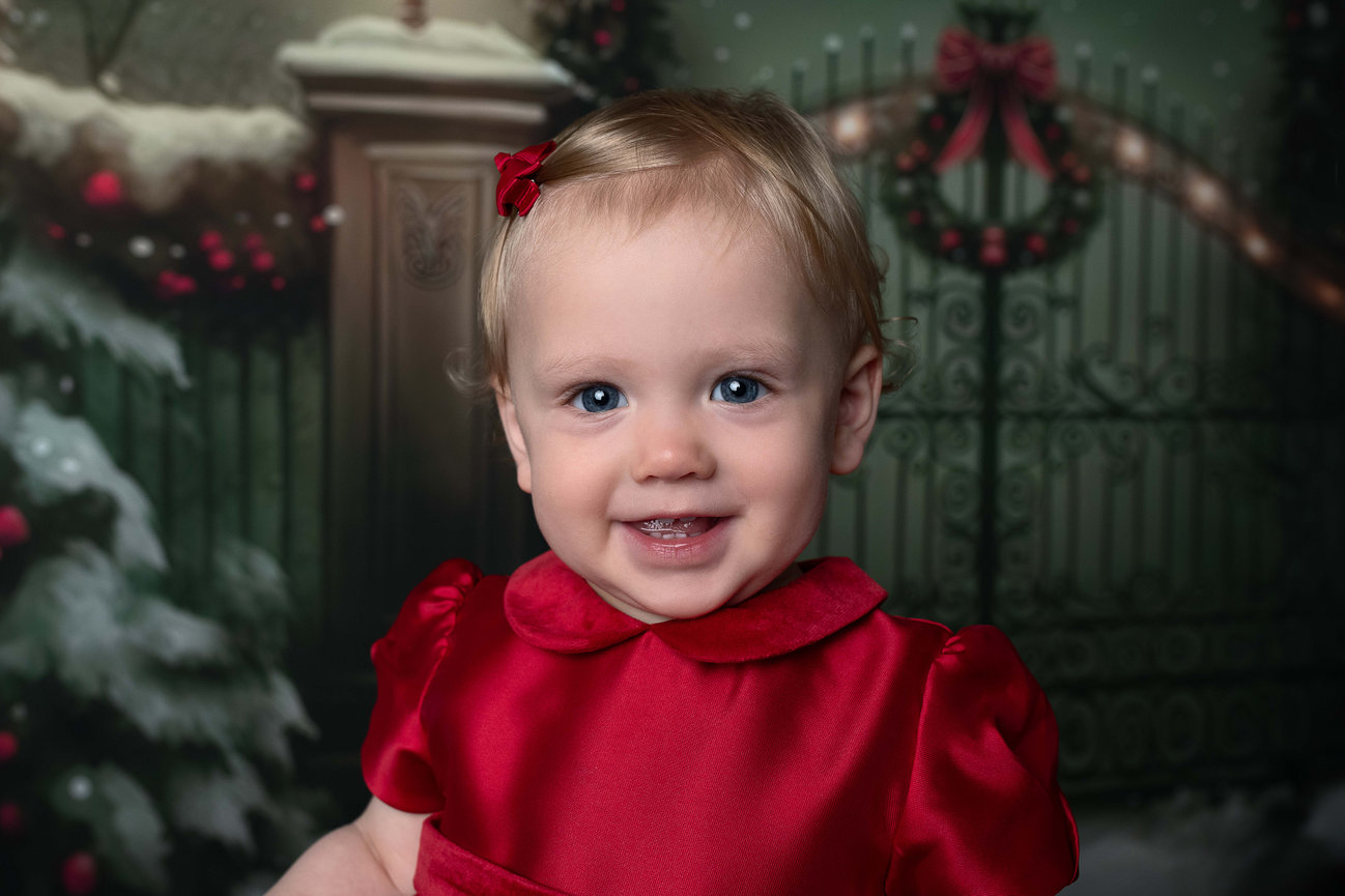 A little girl smiling for Christmas photos