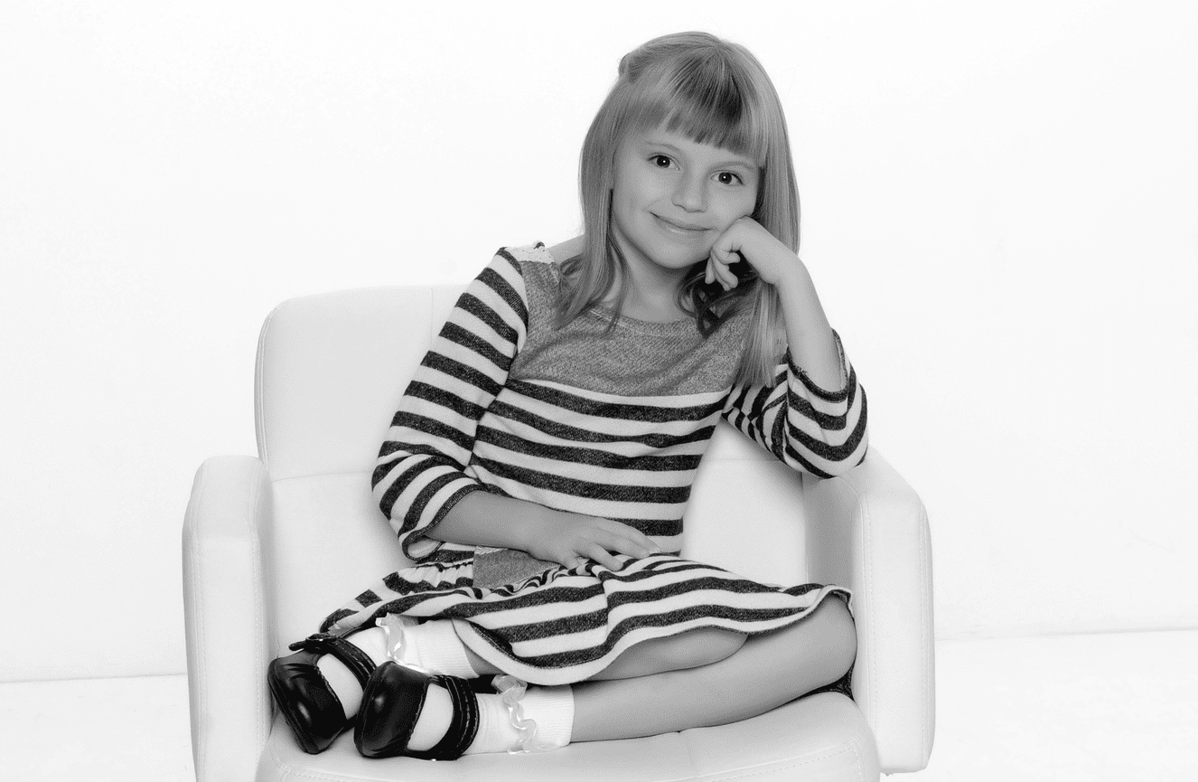 Evelyn when she was a young girl wearing lace socks and paten leather shoes.