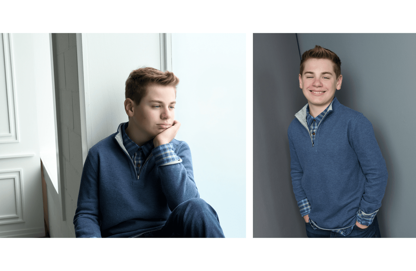 A teenaged boy in a blue sweater looking contemplatively out the window.
