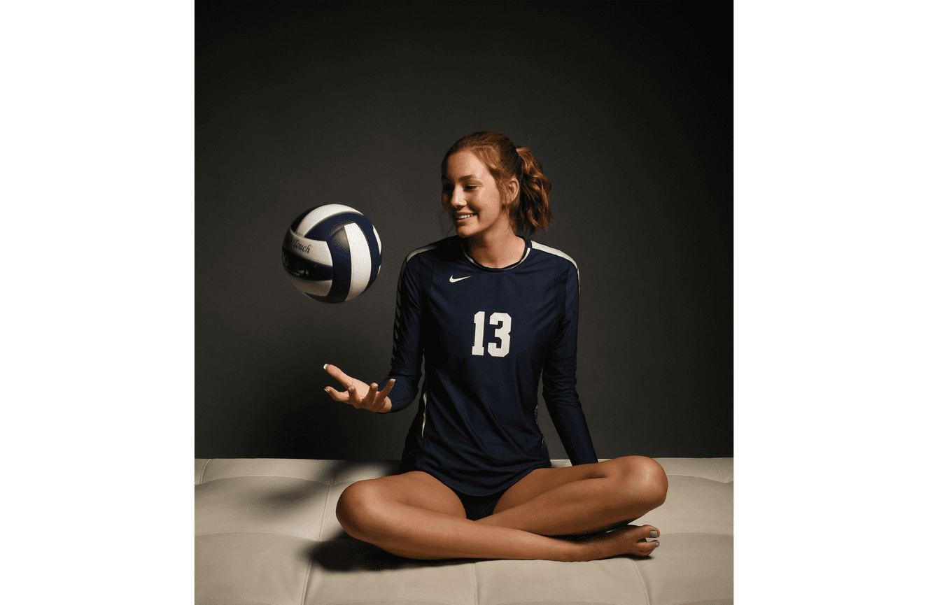An all state volley ball player in her jersey tossing a ball into the air.