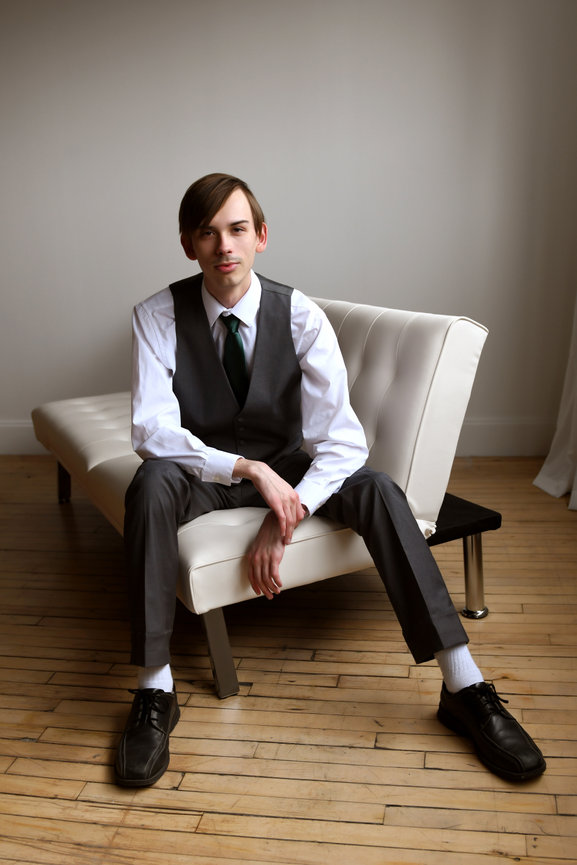A young man wearing his show choir vest and tie during his senior photo session.