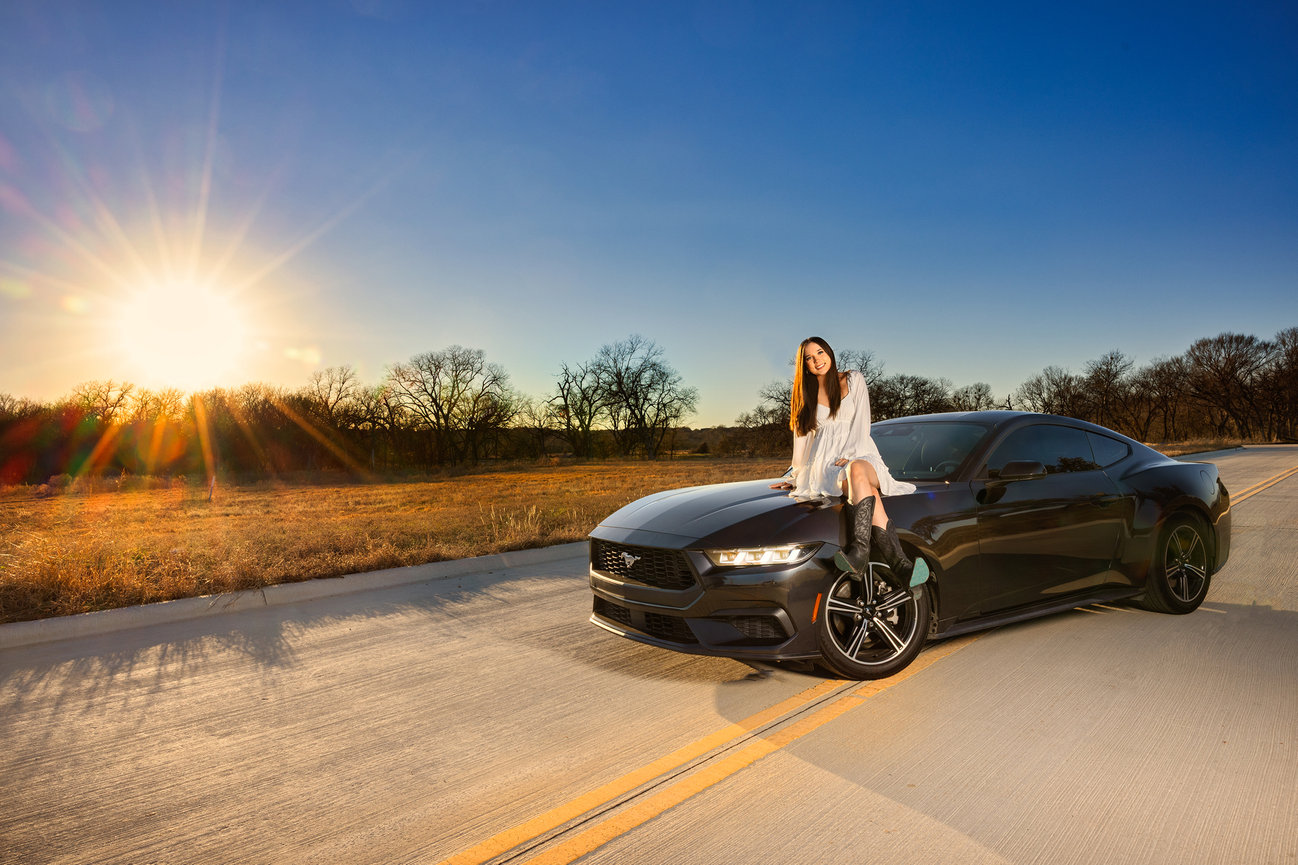 Graduating senior portrait of a girl and her mustang car.