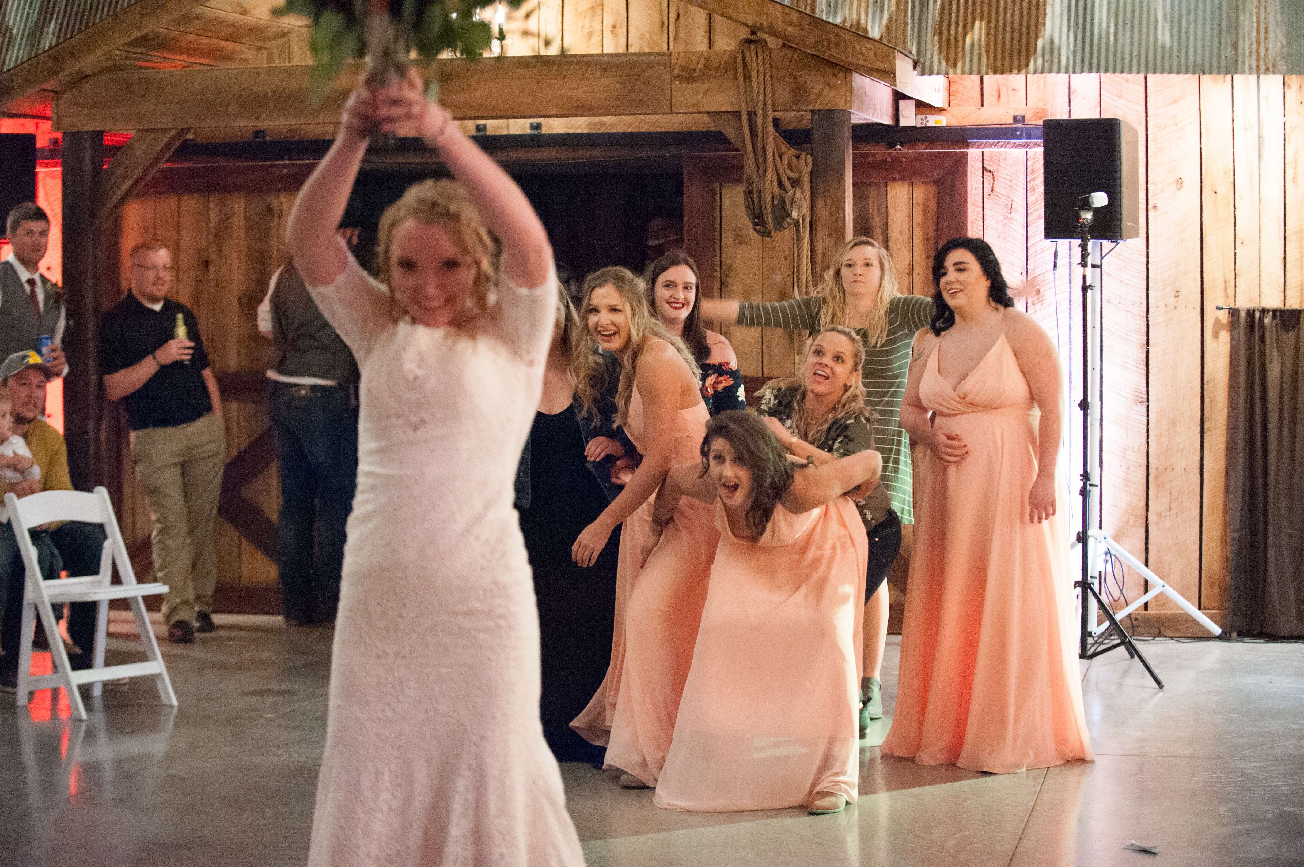 Bride throwing bouquet after her wedding ceremony near Springfield, Missouri.