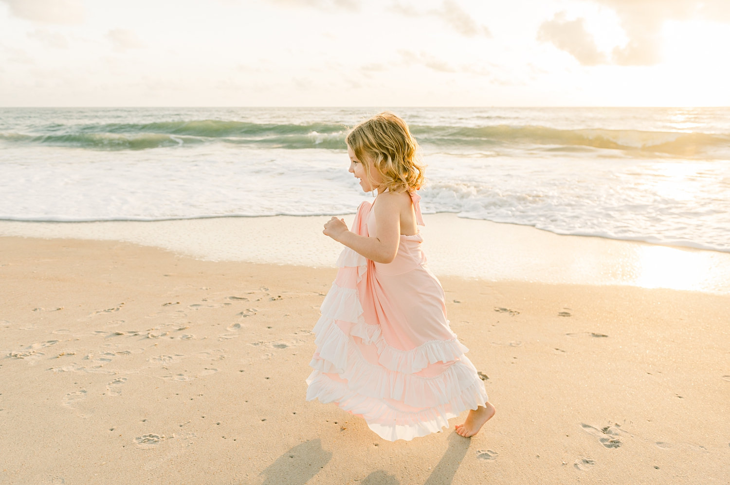 sweet little girl running along St. Augustine Beach at sunrise, Ryaphotos